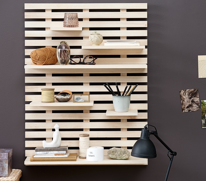 Wooden wall shelf with tealight holder, a mug with pencils and other décor 