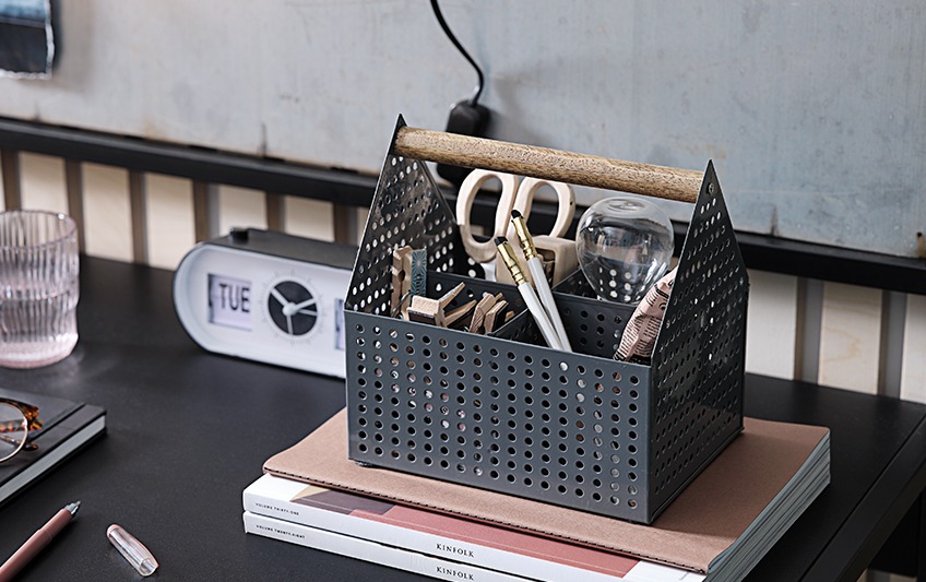 Open storage box with handle, containing scissors, pens, pegs Open storage box with handle, containing scissors, pens, pegs
