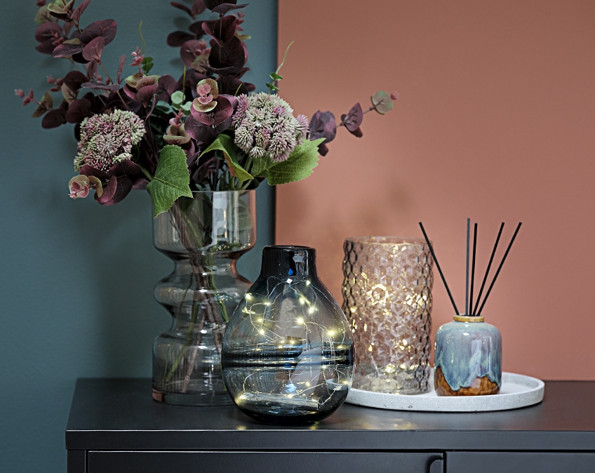 Vases with light strings and flowers on a table Vases with light strings and flowers on a table