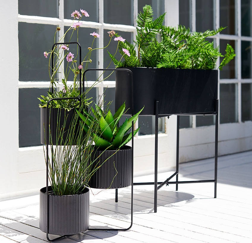 Planter box and plant pot holder on a sunny patio  