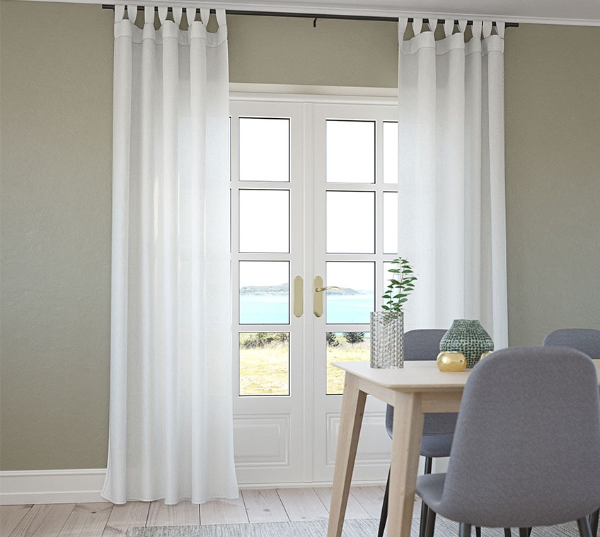 Dining room with lightweight curtains in front of the window