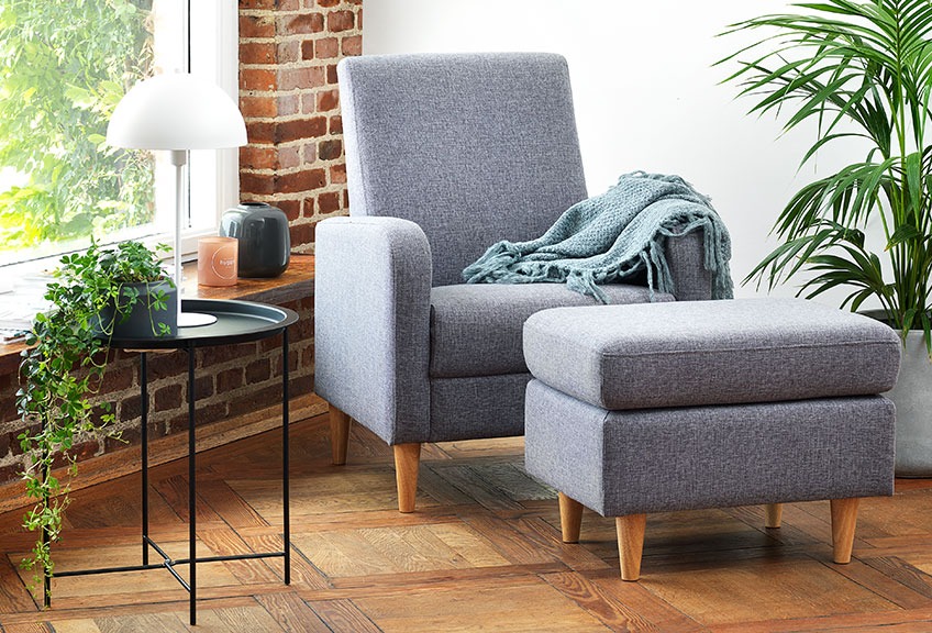 Living room with an armchair and a matching grey ottoman 