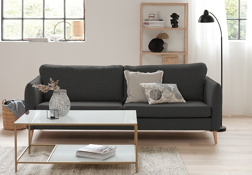 Grey fabric sofa and a coffee table in white and gold look 