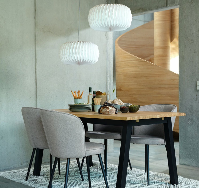 Eettafel met vier grijze eetkamerstoelen en twee witte hanglampen Eettafel met vier grijze eetkamerstoelen en twee witte hanglampen