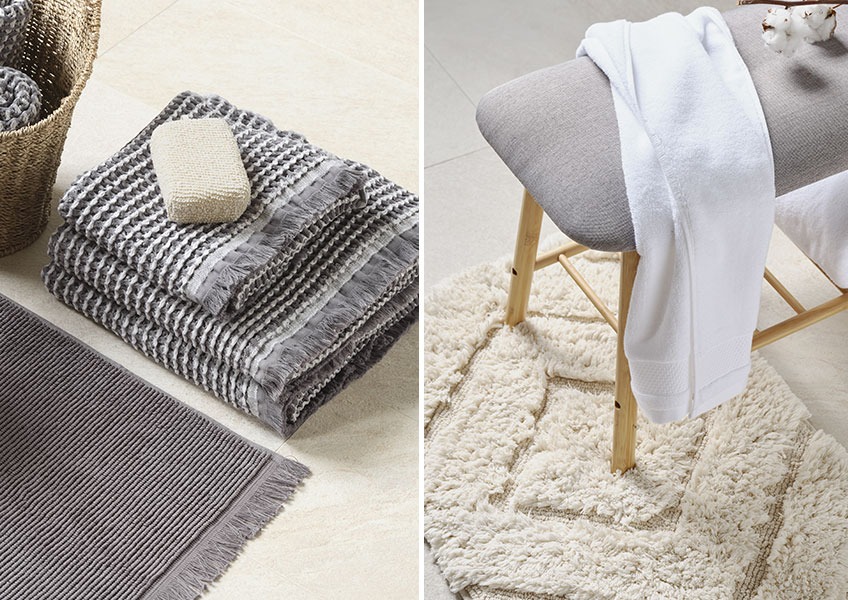 IDRE grijze handdoek en GIMO off white badmat Grijze handdoek met wafelstructuur en witte handdoek op een bankje op een off-white badmat