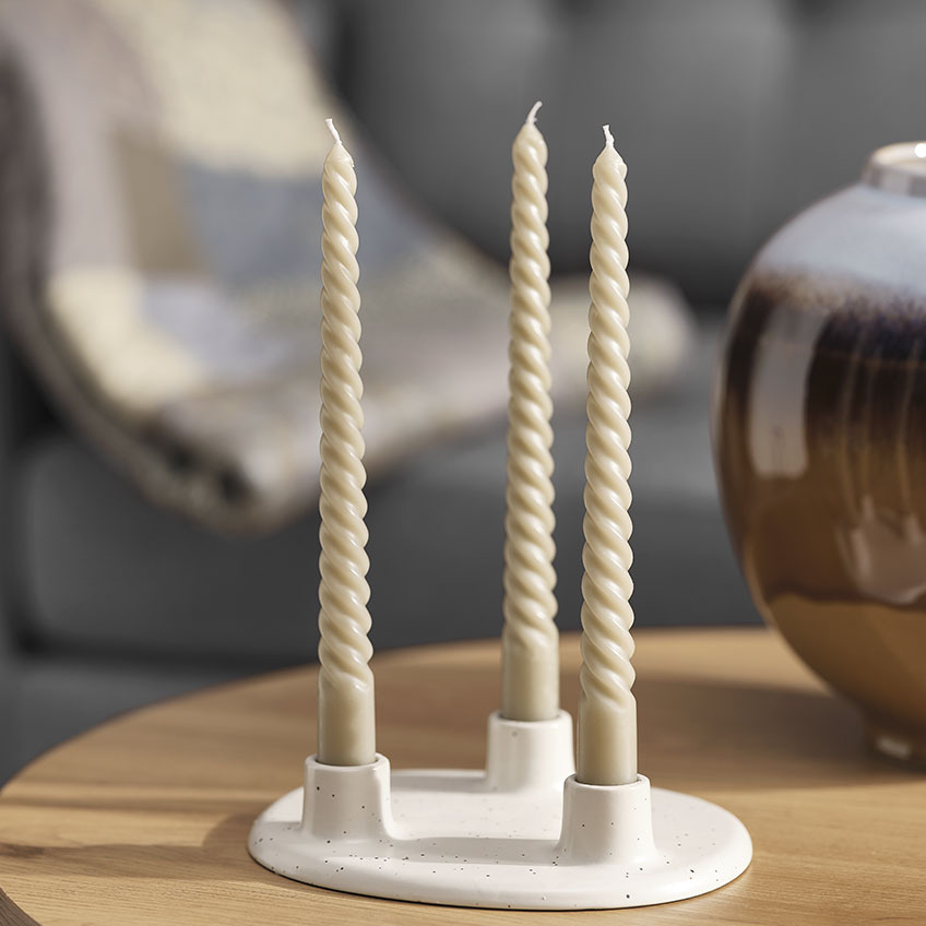 Twisted candles in white candlestick
