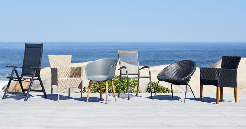 Dining chairs on patio by the beach